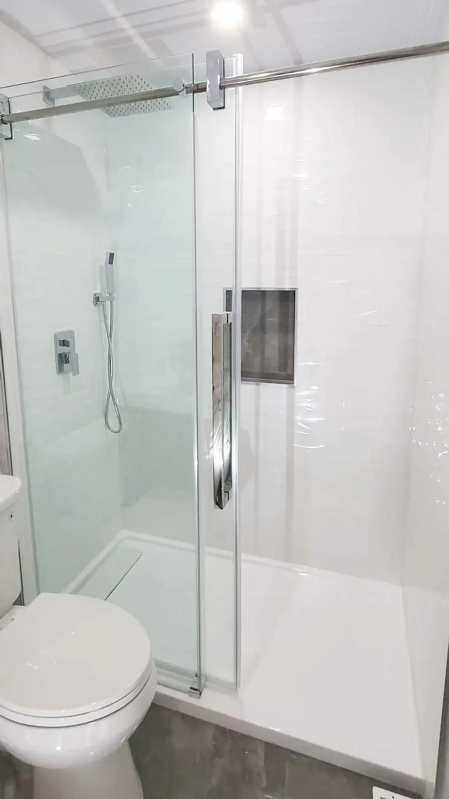 Walk-in glass shower with large-format porcelain tile and vertical mosaic accent strip, photo 1
