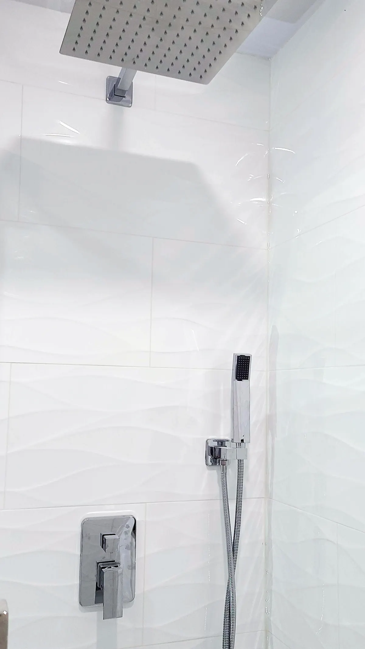 Walk-in glass shower with large-format porcelain tile and vertical mosaic accent strip, Coquitlam bathroom renovation