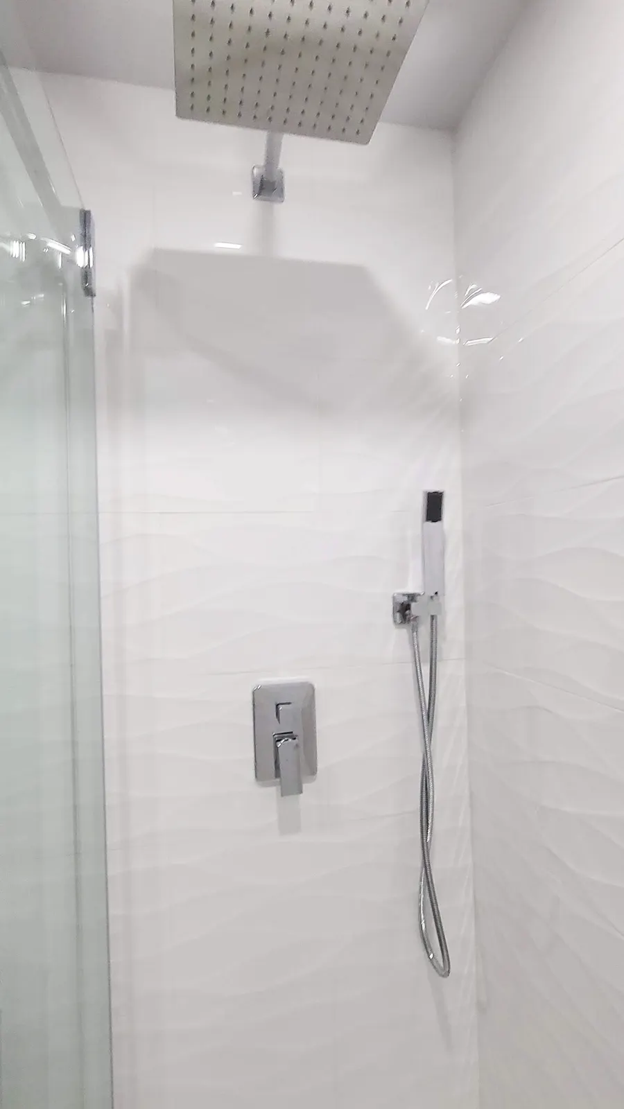 Walk-in glass shower with large-format porcelain tile and vertical mosaic accent strip, photo 11